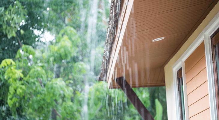 rain dripping from eaves of a house