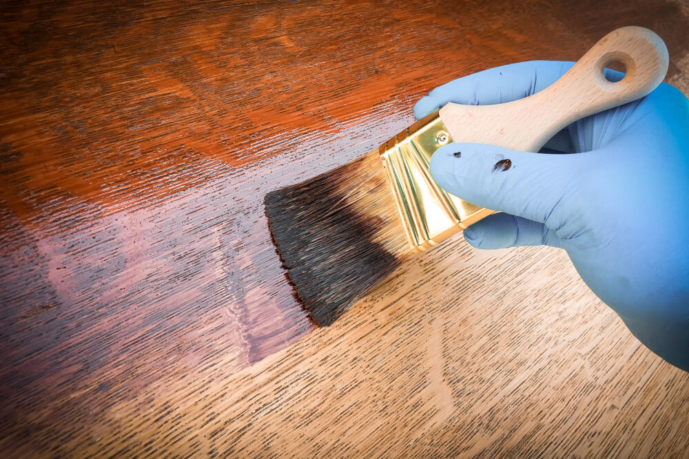 applying finish to wooden board