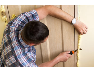 man cutting insulation