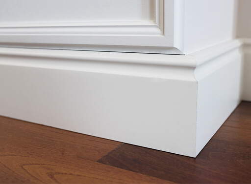 Image of molding placed on top of laminate flooring